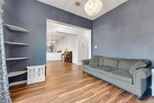 living room featuring an inviting chandelier and wood-type flooring