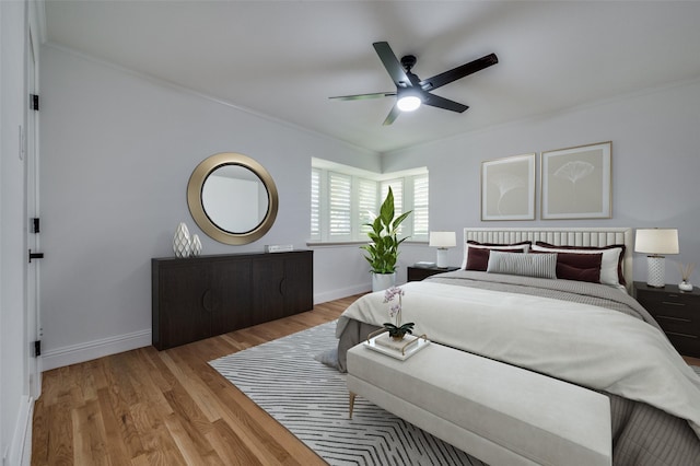 bedroom featuring light hardwood / wood-style floors, ceiling fan, and ornamental molding