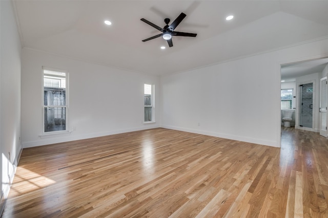 unfurnished room with light hardwood / wood-style floors, a tray ceiling, crown molding, and ceiling fan