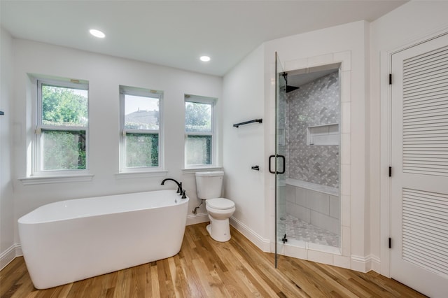 bathroom featuring hardwood / wood-style floors, independent shower and bath, and toilet