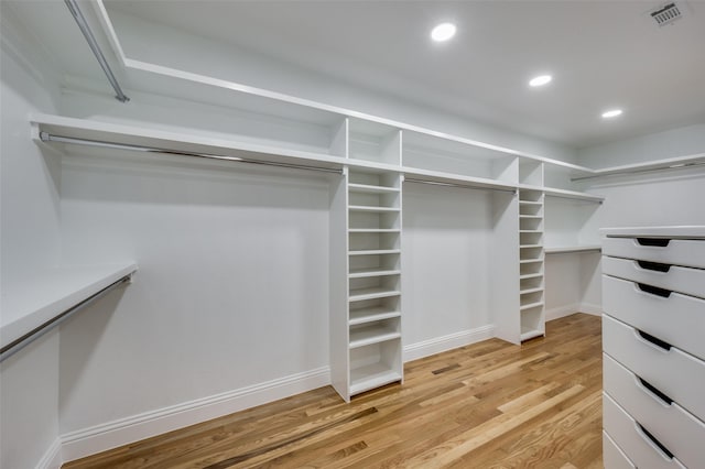 spacious closet with light hardwood / wood-style flooring