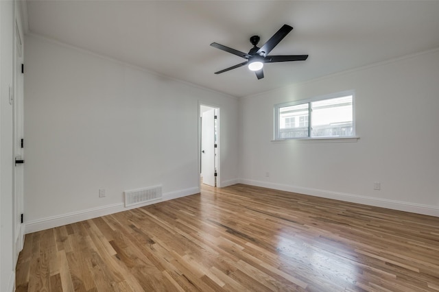 spare room featuring light wood-type flooring, ceiling fan, and ornamental molding