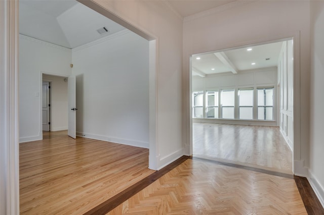 unfurnished room with light parquet floors, beam ceiling, and crown molding