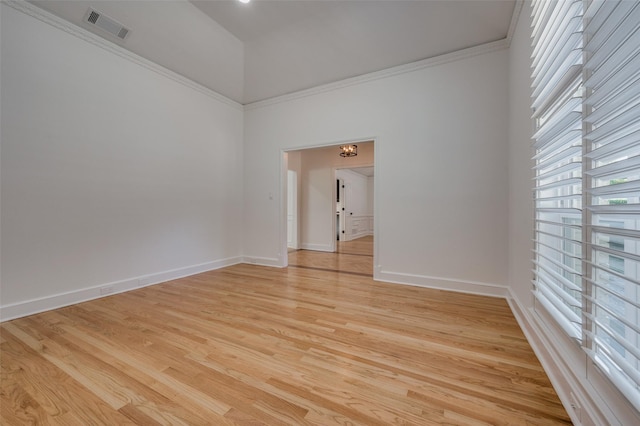 unfurnished room featuring light hardwood / wood-style flooring and ornamental molding