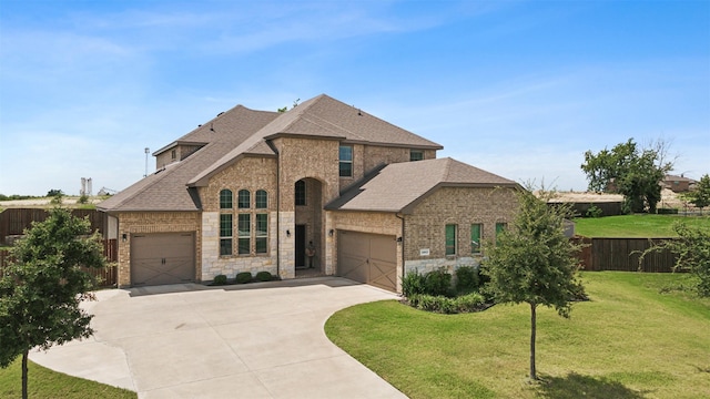 view of front facade with a garage and a front lawn