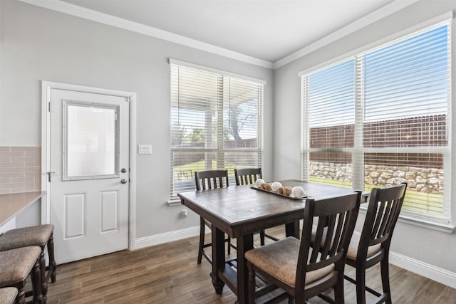 dining area with crown molding and dark hardwood / wood-style floors