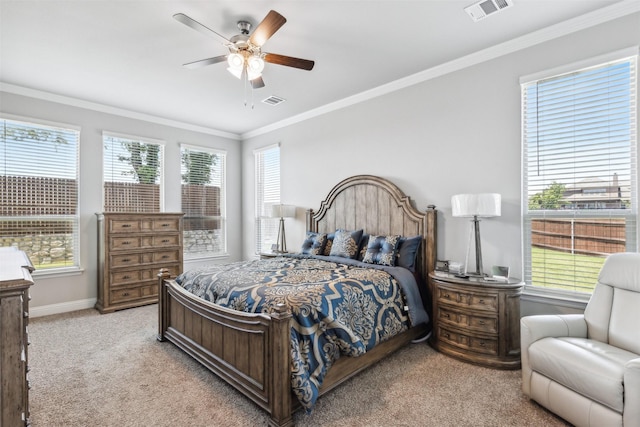 bedroom featuring ornamental molding, ceiling fan, light colored carpet, and multiple windows