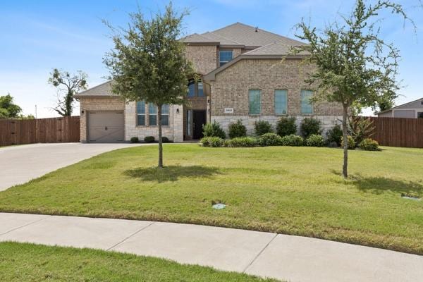 view of front of home featuring a garage and a front lawn