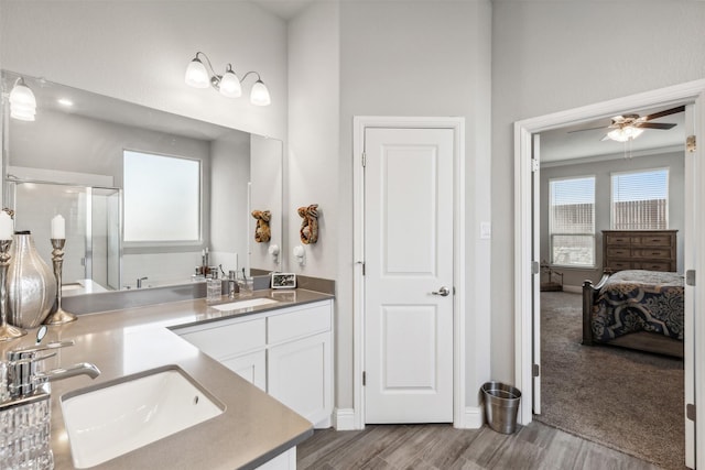 bathroom with wood-type flooring, an enclosed shower, ceiling fan, and vanity