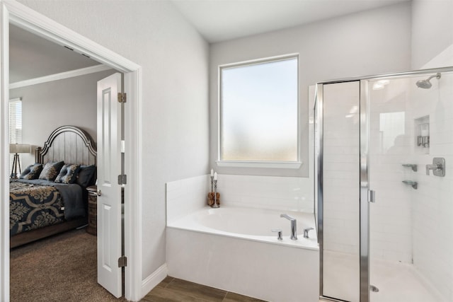 bathroom with crown molding, plus walk in shower, and plenty of natural light