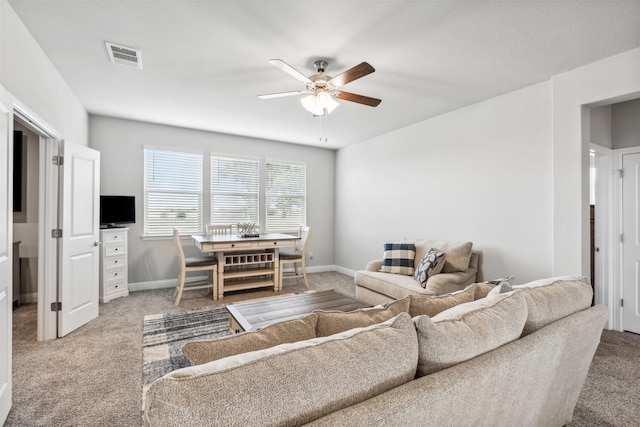 living room with ceiling fan and carpet flooring