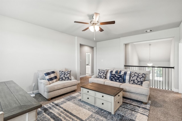 living room featuring ceiling fan and carpet