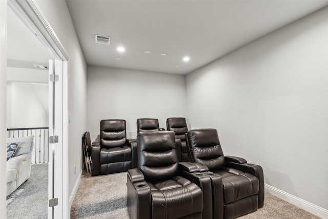 cinema room featuring light colored carpet