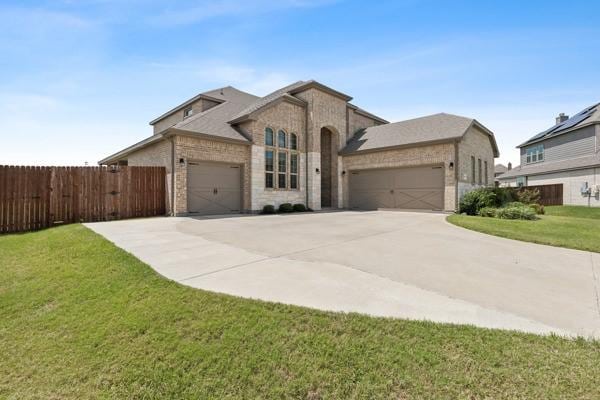 view of front of house featuring a garage and a front yard