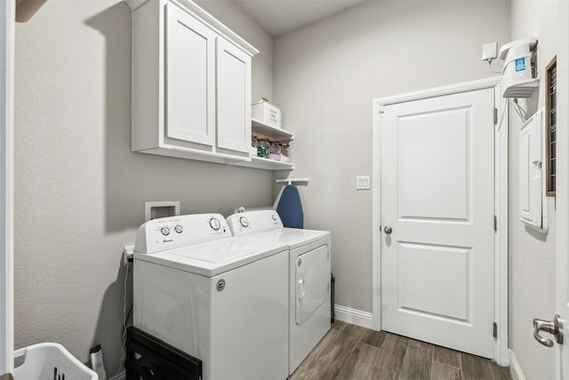 washroom with washing machine and clothes dryer and cabinets