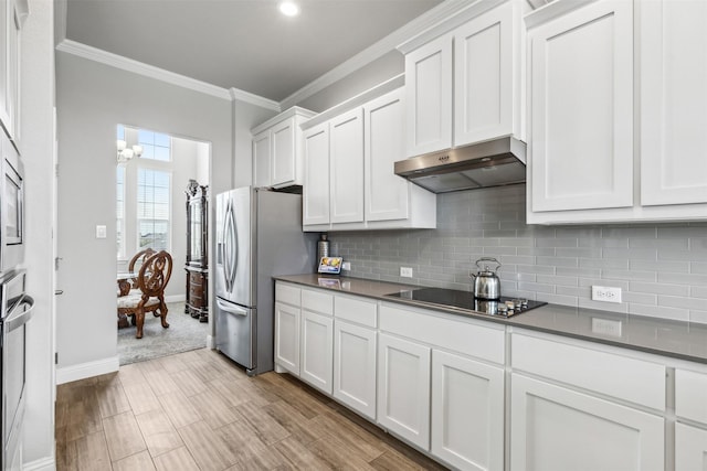 kitchen featuring crown molding, white cabinetry, decorative backsplash, and stainless steel appliances