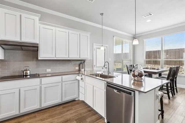 kitchen featuring white cabinets, decorative light fixtures, sink, stainless steel dishwasher, and black electric cooktop