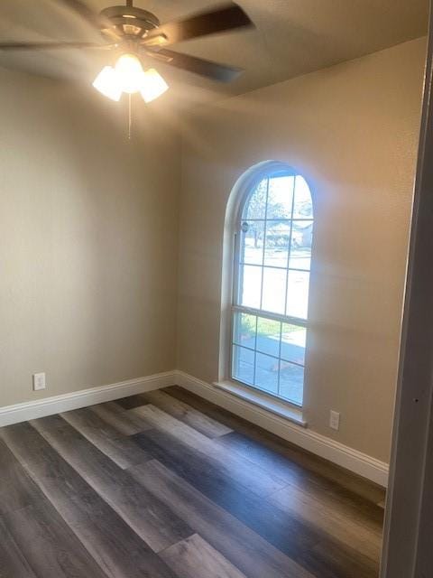 empty room featuring ceiling fan and dark hardwood / wood-style floors