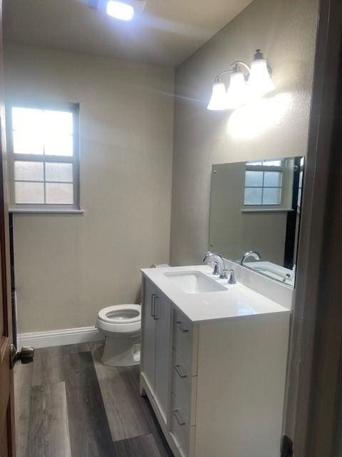 bathroom featuring vanity, hardwood / wood-style floors, and toilet