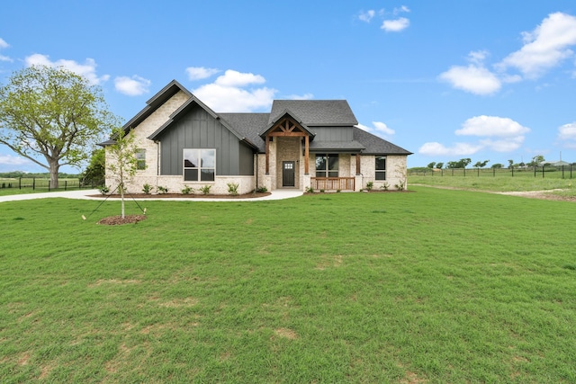 craftsman house featuring a front yard and a rural view