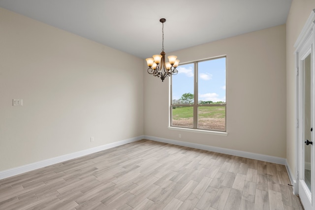 unfurnished room with light hardwood / wood-style floors and a notable chandelier