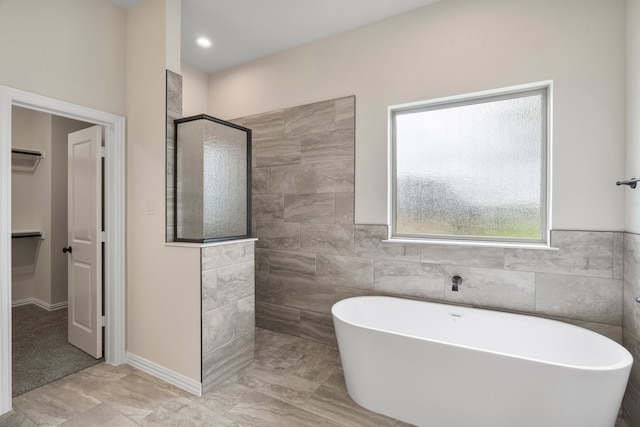 bathroom with separate shower and tub