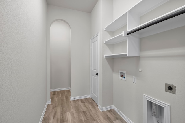 laundry area with light wood-type flooring, gas dryer hookup, hookup for a washing machine, and hookup for an electric dryer