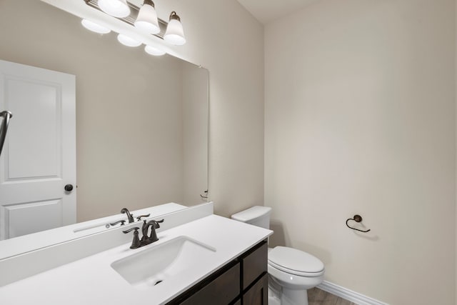 bathroom featuring vanity and toilet