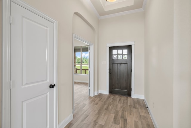 foyer entrance featuring light hardwood / wood-style floors and ornamental molding