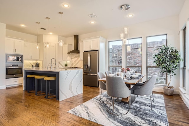 dining space featuring sink and dark hardwood / wood-style floors