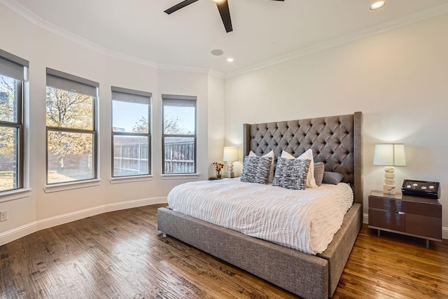 bedroom with ceiling fan, dark wood-type flooring, and multiple windows