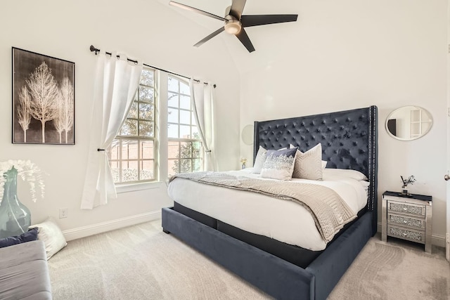 carpeted bedroom with ceiling fan and vaulted ceiling