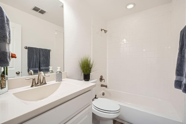 full bathroom with tiled shower / bath combo, toilet, and vanity