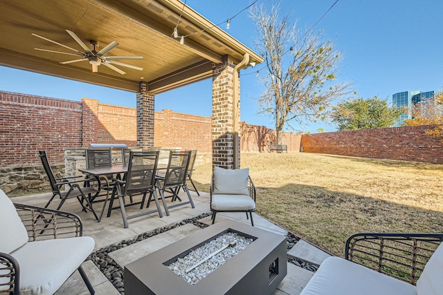 view of patio / terrace featuring ceiling fan and a fire pit