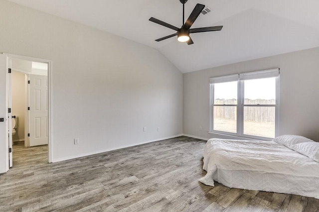 unfurnished bedroom featuring light wood-type flooring, ceiling fan, and vaulted ceiling