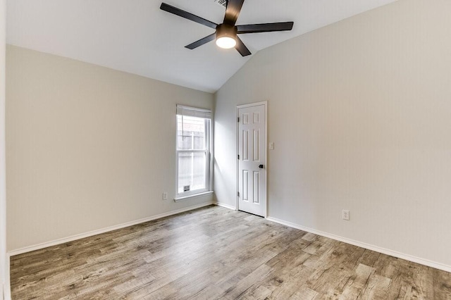 unfurnished room featuring light hardwood / wood-style flooring, vaulted ceiling, and ceiling fan