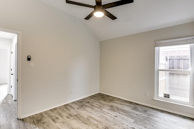 empty room with light wood-type flooring, vaulted ceiling, and ceiling fan