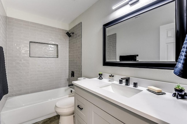 full bathroom with vanity, toilet, and tiled shower / bath