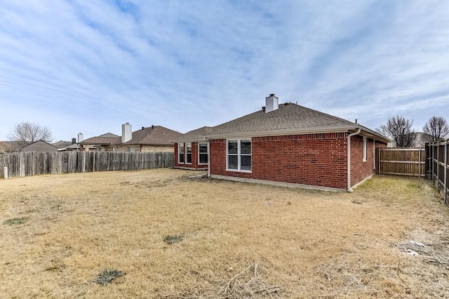 rear view of property featuring a yard