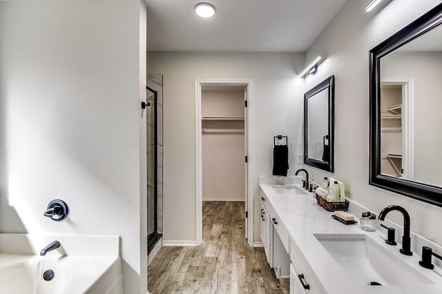 bathroom featuring vanity, separate shower and tub, and wood-type flooring