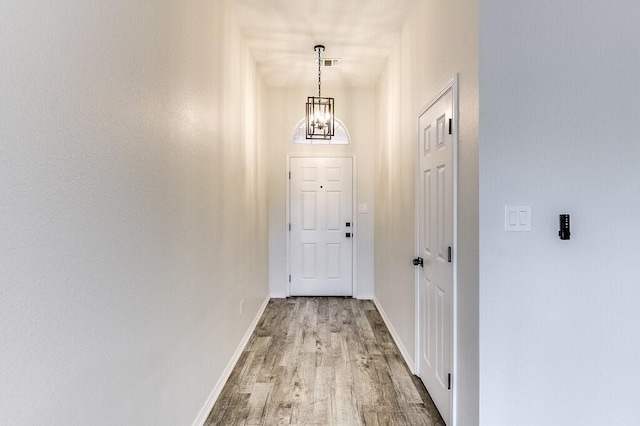 entryway with a chandelier and light hardwood / wood-style flooring