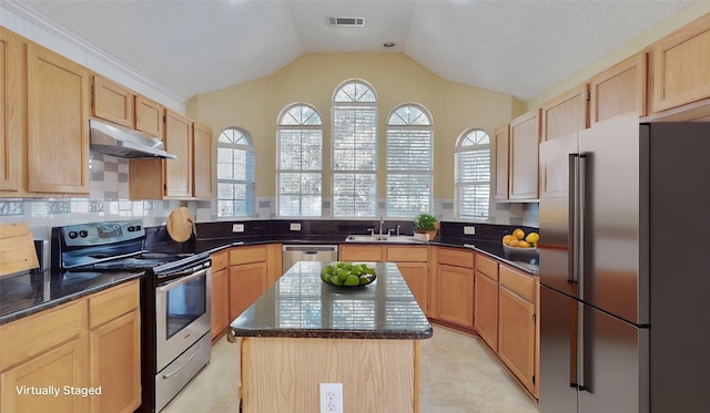 kitchen featuring light brown cabinets, sink, a kitchen island, lofted ceiling, and stainless steel appliances