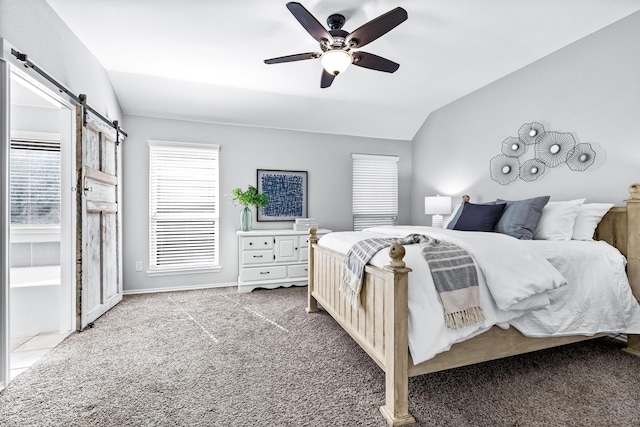 carpeted bedroom with a ceiling fan, lofted ceiling, baseboards, and a barn door