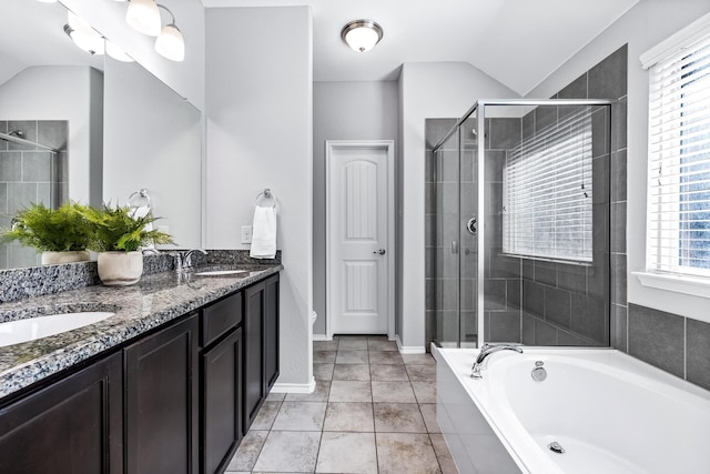 bathroom with tile patterned floors, lofted ceiling, plus walk in shower, and vanity