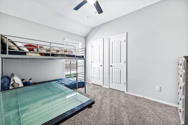 carpeted bedroom featuring lofted ceiling and ceiling fan