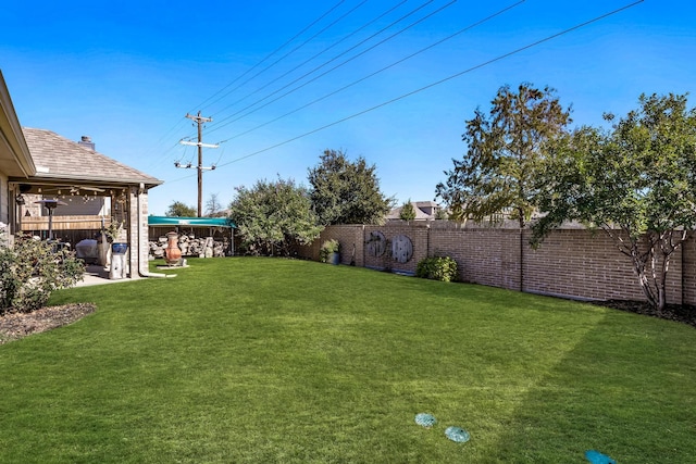 view of yard with a fenced backyard and a patio