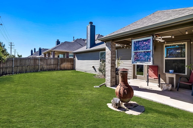 view of yard with fence and a patio