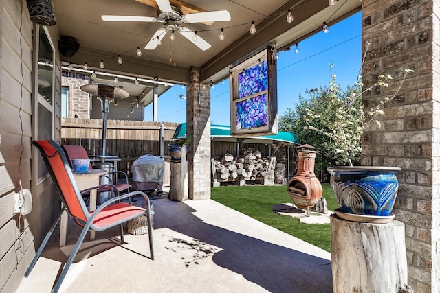 view of patio / terrace with a ceiling fan and fence