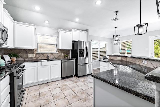 kitchen featuring light tile patterned flooring, white cabinetry, sink, hanging light fixtures, and stainless steel appliances