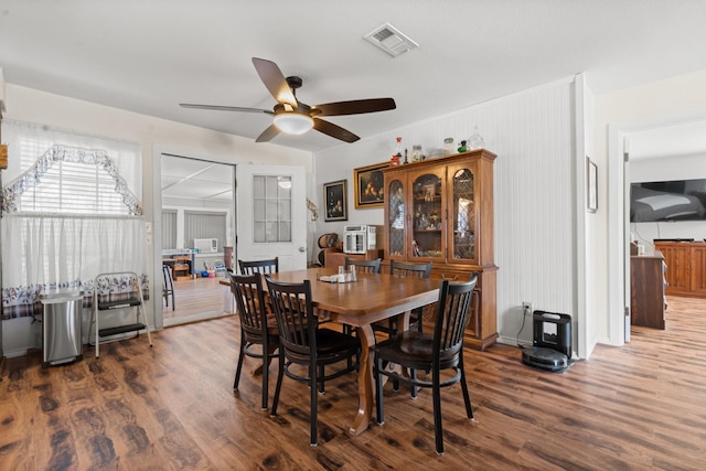 dining area with ceiling fan and dark wood-type flooring